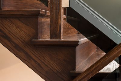 custom wood staircase with tinted glass railing