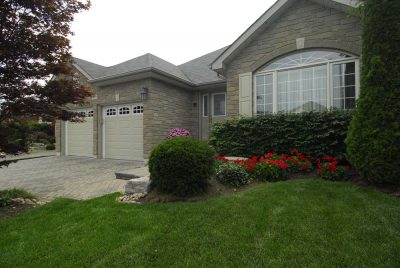 custom home with garage doors with windows